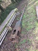A cast iron Victorian/Victorian style street lamp base Situated next to far hedge