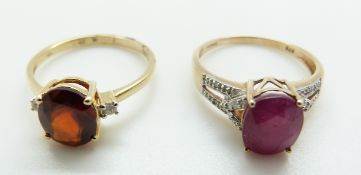 A 9ct gold ring set with a garnet and diamonds and a 9ct gold ring set with a ruby and diamonds,