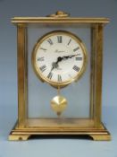 Rapport c1960s single train brass carriage style clock with pendulum and keyless 8-day movement.