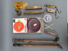 A quantity of tools including spring balances, measuring tapes,