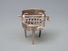 A white metal novelty barbecue with rotating spit roast, marked 800, height 42mm,