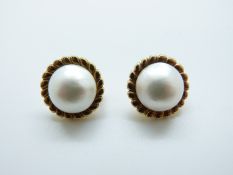 A pair of yellow metal earrings set with a Mabé pearl to each, 11.