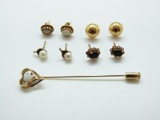 A pair of 14k gold earrings, a pair of yellow metal earrings set with opals,