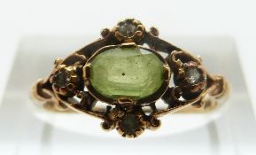 A 9ct gold ring set with a peridot and diamonds, size M, 2.