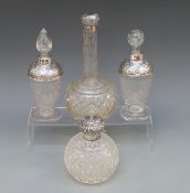 Four silver topped cut glass scent bottles including a hobnail cut example