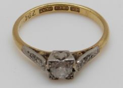 An 18ct gold ring set with a diamond of approximately 0.