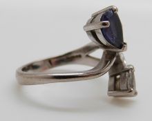 An 18ct white gold ring set with a pear cut tanzanite and a pear cut diamond, size I/J, 4.