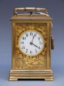 A French c1900 brass cased repeater carriage clock with beaded decoration to case and floral and