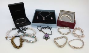 A collection of jewellery to include four silver bracelets, one set with quartz,