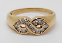 An 18ct gold ring set with diamonds in a twist, 3.