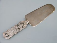 A white metal cake slice with pierced foliate handle, marked Peru 925, length 20cm,