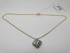 A 9ct gold pendant set with topaz and diamonds on 9ct gold chain