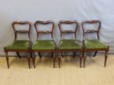 A set of four Victorian rosewood dining chairs with turned and carved front legs