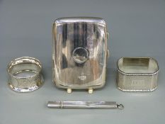 A hallmarked silver cigarette case, two silver napkin rings and a hallmarked silver pencil holder ,
