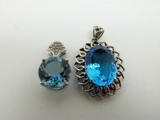 A 9ct white gold pendant set with topaz and diamonds and a 9ct white gold pendant set with topaz