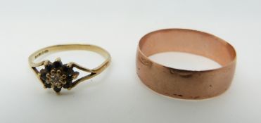 A 9ct gold wedding band ( size Q) and a 9ct gold ring set with a diamond and sapphires in a cluster