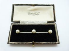 A 9ct gold brooch set with faux pearls in original box