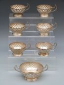 A set of six white metal cup holders and matching sugar bowl holder, believed to be Middle Eastern,