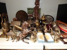 A quantity of brassware to include miniature cannon, bell, rickshaw, animals, Venetian gondala,