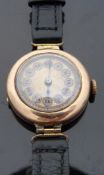 A 9ct gold ladies wristwatch with blued hands, gold face, inset black Roman numerals,