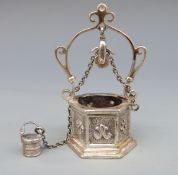 A white metal novelty hexagonal wishing well with chain, pulley and bucket, marked Medusa-Ora,