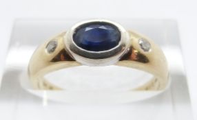 A 9ct gold ring set with an oval sapphire and two diamonds, size M, 2.