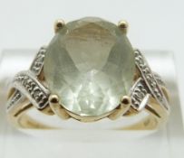 A 9ct gold ring set with an oval cut topaz and two diamonds, size Q, 3.