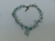 An aquamarine necklace made up of irregular pieces and natural rough sections