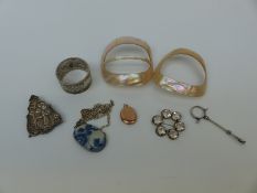 Two mother of pearl buckles, a paste brooch,