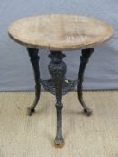 A pub table with cast iron base decorated with ladies faces