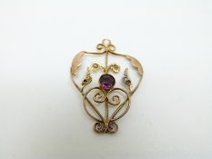 A 9ct gold Edwardian/ Art Nouveau pendant set with an amethyst