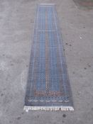 A Persian woollen runner on blue ground,