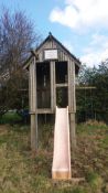 A child's wooden garden play tower complete with swings and slide