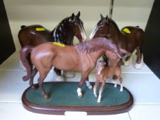 Two Beswick standing Shire horses and a Royal Doulton 'First Born' figure