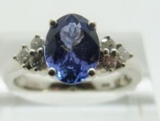 An 18ct white gold ring set with a tanzanite and diamonds, size N/O, 4.