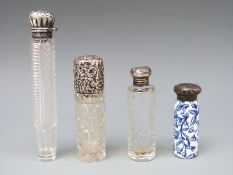 Four hallmarked silver mounted glass and porcelain scent bottles, three Victorian,