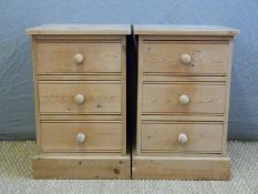 A pair of pine three drawer bedside cabinets,