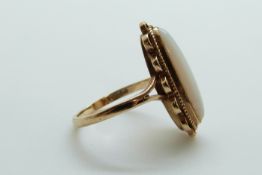 A 9ct gold ring set with an opal cabochon, size P/Q, 4.