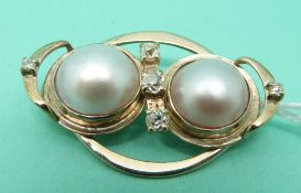 A 9ct gold brooch set with two Mabé pearls and five old cut diamonds