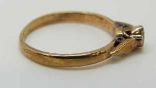 A 9ct gold ring set with a round cut diamond of approximately 0.