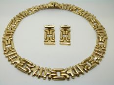 A 14k gold necklace and matching earrings,