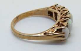 A 9ct gold ring set with five graduated opals, size O, 4.