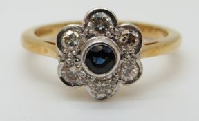 An 18ct gold ring set with a sapphire surrounded by diamonds in a daisy cluster, size O, 4.