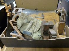 A qunatity of vintage woodworking tools including planes, saws,