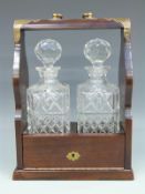A two bottle tantalus with Edinburgh Crystal decanters,