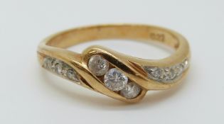 An 18ct gold ring set with diamonds totalling approximately 0.22ct in a twist setting, 2.