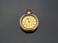 A 9ct gold ladies keyless winding open faced pocket watch with engraved self coloured face,