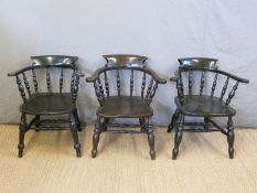 Three elm seated Windsor captain's chairs
