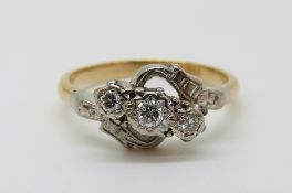 An 18ct gold ring set with three diamonds in a platinum setting (size P)