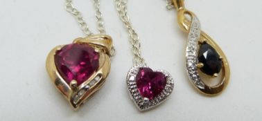 Two 9ct gold pendants set with synthetic rubies and a 9ct gold pendant set with a sapphire and